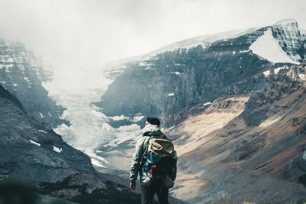 hombre haciendo trekking mirando una montaña